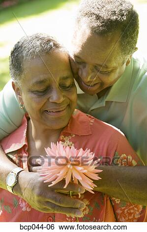 Man giving woman a flower View Large Photo Image Stock Photograph - Man giving woman a flower. Fotosearch