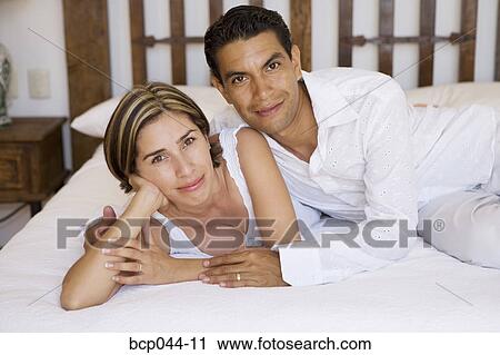 Portrait of couple on bed View Large Photo Image Stock Image - Portrait of couple on bed. Fotosearch