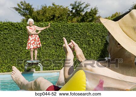 Senior couple having poolside fun View Large Photo Image Stock Image - Senior couple having poolside fun. Fotosearch