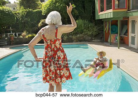 Senior couple having poolside fun View Large Photo Image Stock Photo - Senior couple having poolside fun. Fotosearch