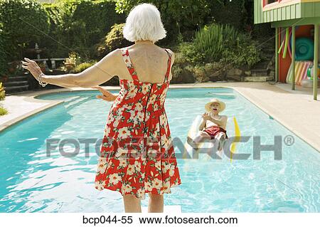 Senior couple having poolside fun View Large Photo Image Stock Photography - Senior couple having poolside fun. Fotosearch