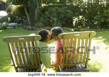 Stock Photo - Seniors kissing outdoors. Fotosearch