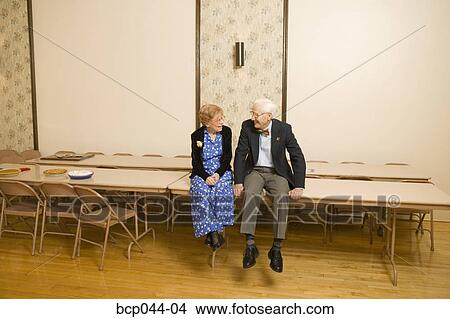 Two seniors sitting and chatting View Large Photo Image Picture - Two seniors sitting and chatting. Fotosearch
