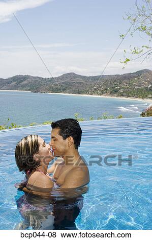 Vacationing couple in swimming pool View Large Photo Image Stock Photo - Vacationing couple in swimming pool. Fotosearch