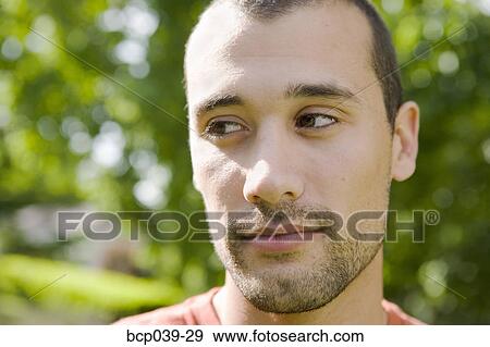 Stock Photo - Closeup of young man outdoors. Fotosearch
