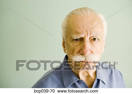 Stock Image - Portrait of annoyed senior man. Fotosearch