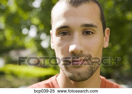 Stock Photography - Portrait of young man outdoors. Fotosearch