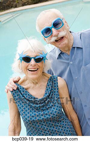 Senior couple in wacky sunglasses View Large Photo Image Stock Photo - Senior couple in wacky sunglasses. Fotosearch