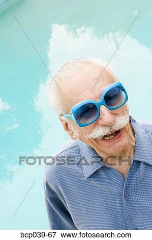 Senior man in wacky sunglasses View Large Photo Image Stock Photo - Senior man in wacky sunglasses. Fotosearch