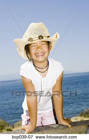 Smiling girl in cowboy hat View Large Photo Image Stock Photo - Smiling girl in cowboy hat. Fotosearch