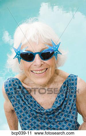 Woman wearing distinctive sunglasses View Large Photo Image Stock Image - Woman wearing distinctive sunglasses. Fotosearch