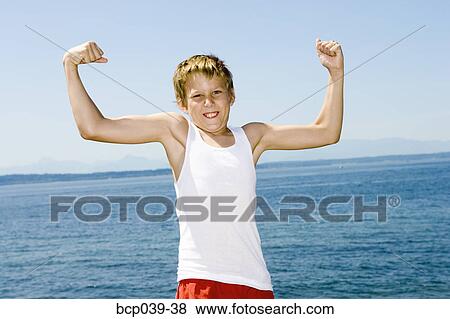 Stock Photo - Young boy flexing his muscles. Fotosearch