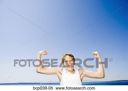 Young boy flexing his muscles View Large Photo Image Stock Photography - Young boy flexing his muscles. Fotosearch