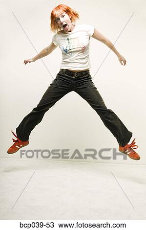 Young woman leaping in the air View Large Photo Image Stock Image - Young woman leaping in the air. Fotosearch