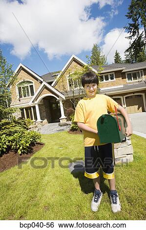 Boy with new mailbox outside house View Large Photo Image Stock Photograph - Boy with new mailbox outside house. Fotosearch