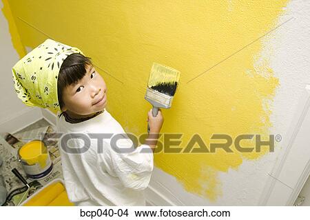 Child concentrating on painting wall View Large Photo Image Picture - Child concentrating on painting wall. Fotosearch
