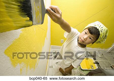 Child concentrating on painting wall View Large Photo Image Stock Photography - Child concentrating on painting wall. Fotosearch