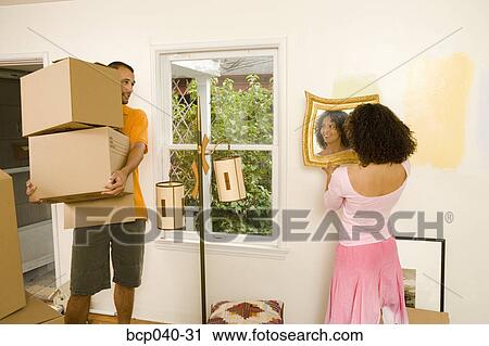 Couple moving into new home View Large Photo Image Stock Image - Couple moving into new home. Fotosearch