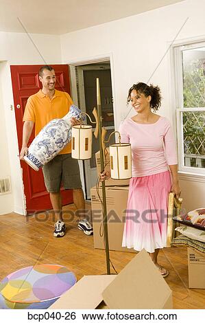 Couple moving into new home View Large Photo Image Stock Photograph - Couple moving into new home. Fotosearch