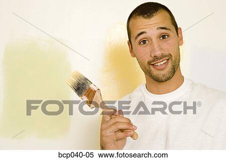 Man with paintbrush choosing color View Large Photo Image Stock Photography - Man with paintbrush choosing color. Fotosearch