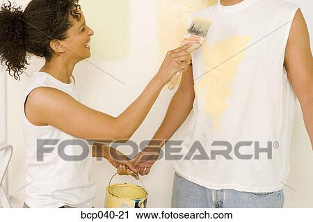 Playful couple choosing paint View Large Photo Image Stock Image - Playful couple choosing paint. Fotosearch