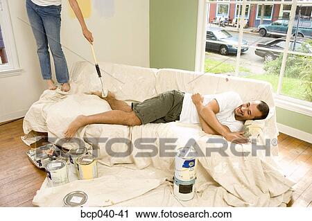 Playful couple doing home decorating View Large Photo Image Stock Image - Playful couple doing home decorating. Fotosearch