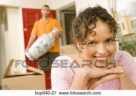 Smiling woman with moving boxes View Large Photo Image Stock Photo - Smiling woman with moving boxes. Fotosearch
