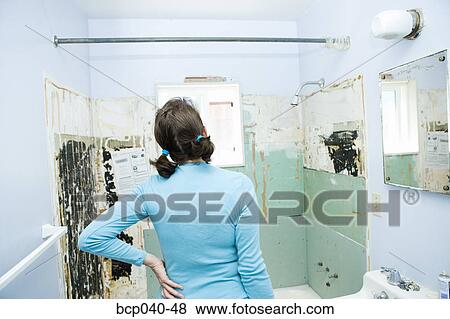 Woman observing shower needing renovation View Large Photo Image Stock Photo - Woman observing shower needing renovation. Fotosearch