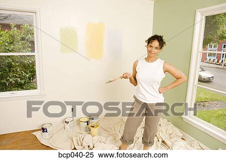 Woman painting interior of house View Large Photo Image Stock Photography - Woman painting interior of house. Fotosearch