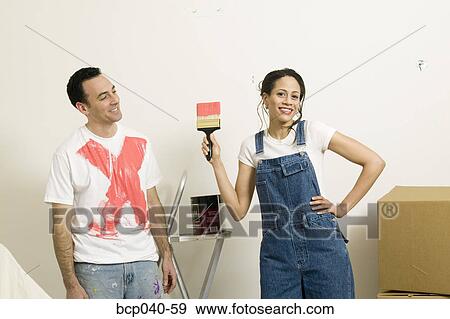 Woman showing off paint on man's shirt View Large Photo Image Stock Photo - Woman showing off paint on man's shirt. Fotosearch