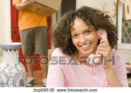 Woman talking on phone while moving View Large Photo Image Stock Image - Woman talking on phone while moving. Fotosearch
