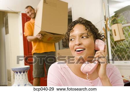 Stock Photo - Woman talking on phone while moving. Fotosearch