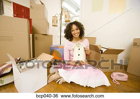 Woman unpacking boxes in new home View Large Photo Image Stock Photograph - Woman unpacking boxes in new home. Fotosearch