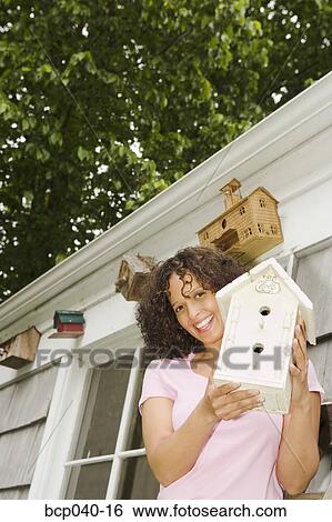 Woman with birdhouse collection View Large Photo Image Stock Photograph - Woman with birdhouse collection. Fotosearch