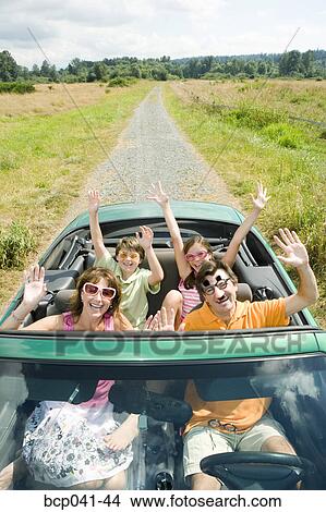 Picture - Enthusiastic silly family in convertible. Fotosearch