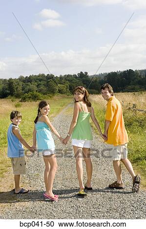 Family holding hands on country road View Large Photo Image Stock Image - Family holding hands on country road. Fotosearch