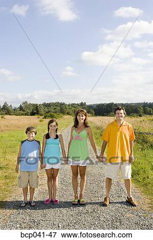 Stock Photo - Family holding hands on country road. Fotosearch