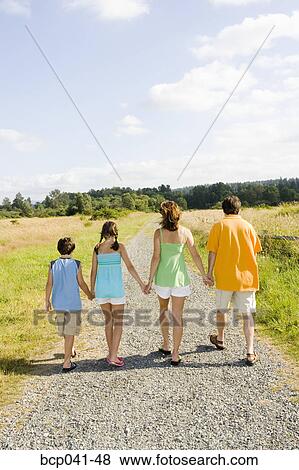 Stock Photo - Family holding hands on country road. Fotosearch