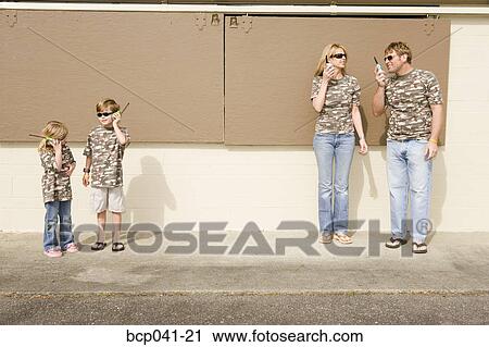 Family in camouflage playing with radios View Large Photo Image Stock Image - Family in camouflage playing with radios. Fotosearch