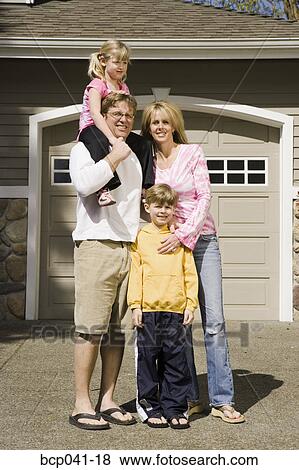 Stock Photo - Family portrait in driveway. Fotosearch