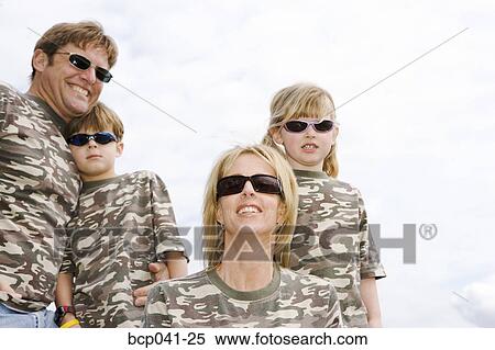 Stock Photography - Family wearing matching camouflage shirts. Fotosearch