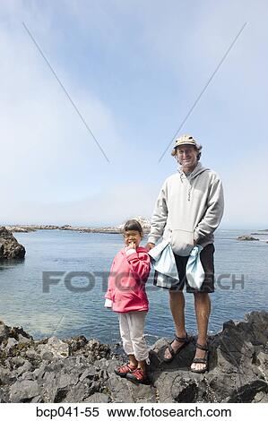 Father and daughter enjoying seaside stroll View Large Photo Image Stock Photography - Father and daughter enjoying seaside stroll. Fotosearch