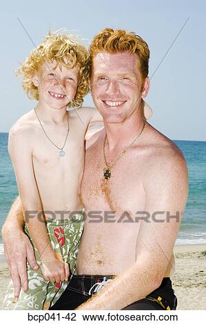 Father and son posing on beach View Large Photo Image Stock Image - Father and son posing on beach. Fotosearch