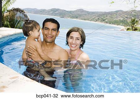 Parents and toddler in tropical pool View Large Photo Image Stock Image - Parents and toddler in tropical pool. Fotosearch