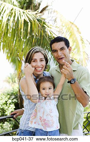 Stock Photo - Parents playing with toddler outside. Fotosearch