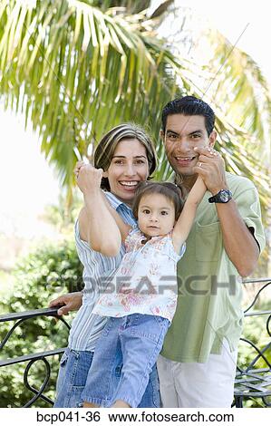 Stock Photograph - Parents playing with toddler outside. Fotosearch