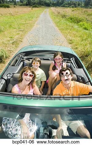 Stock Photograph - Playful family in convertible. Fotosearch