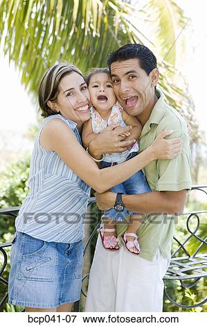Playful parents with little girl View Large Photo Image Stock Photo - Playful parents with little girl. Fotosearch