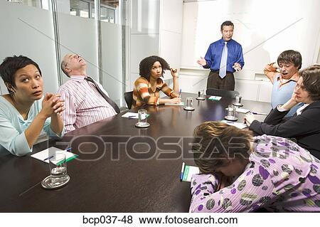 Bored and tired co-workers in meeting View Large Photo Image Stock Photo - Bored and tired co-workers in meeting. Fotosearch