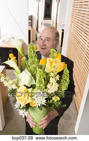 Stock Photo - Businessman holding bouquet of flowers. Fotosearch